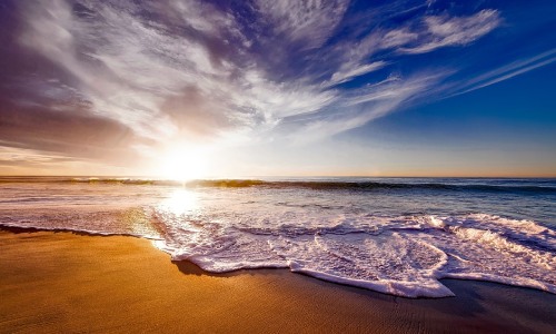 Peaceful beach at sunrise for relaxing travel experience